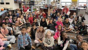 Mr. Fowley sits with our third graders.