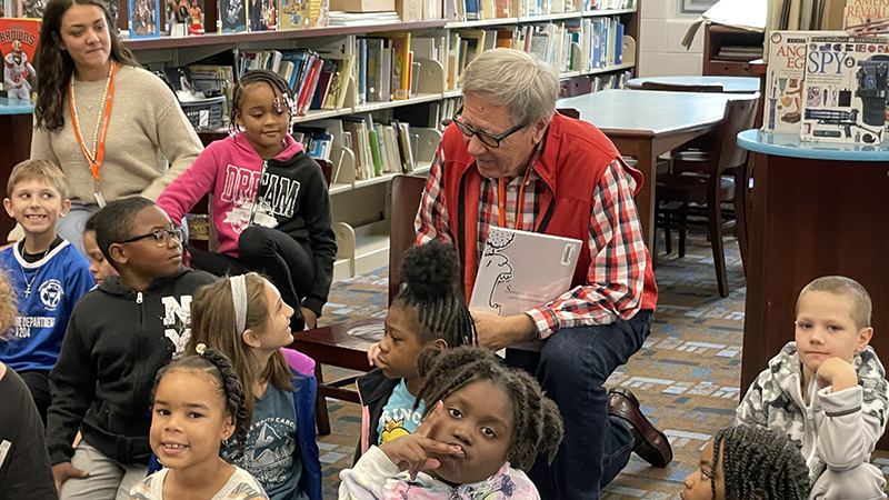 Mr. Fowley talks with a student after the story time.