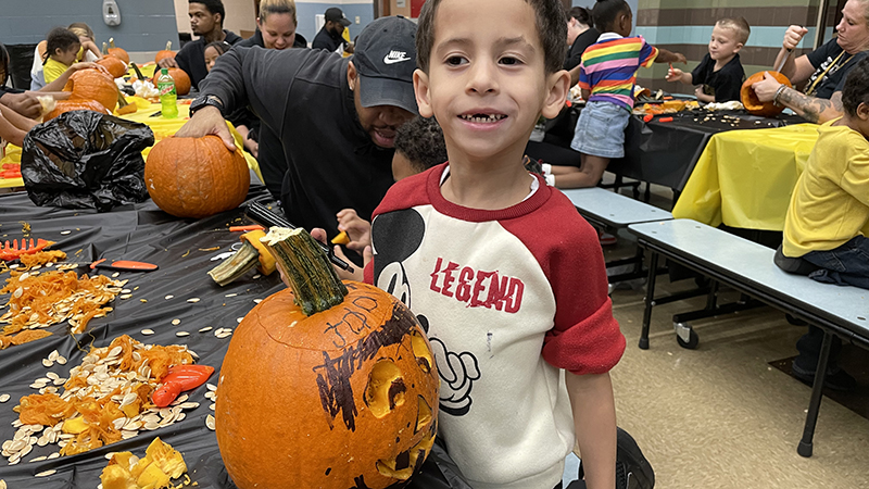 A student shows his finished pumpkin.