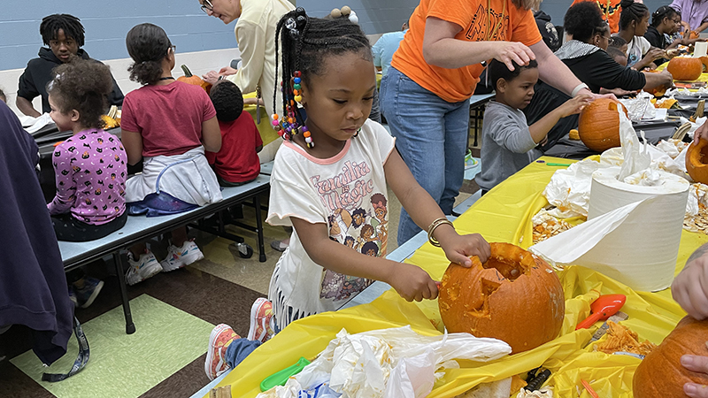 A student works on her pumpkin.