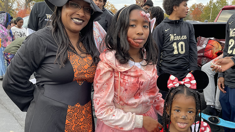 Jefferson secretary, Ms. Tia and her family enjoy Trunk or Treat.