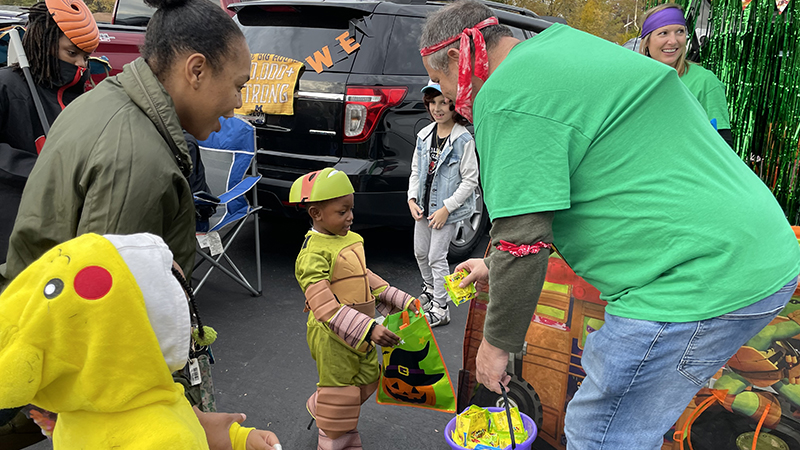 Mr. Seidel passes out candy to another Ninja Turtle.