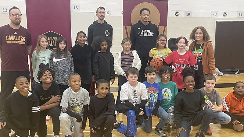 Fourth grade students get their picture with the Cavs Academy reps.
