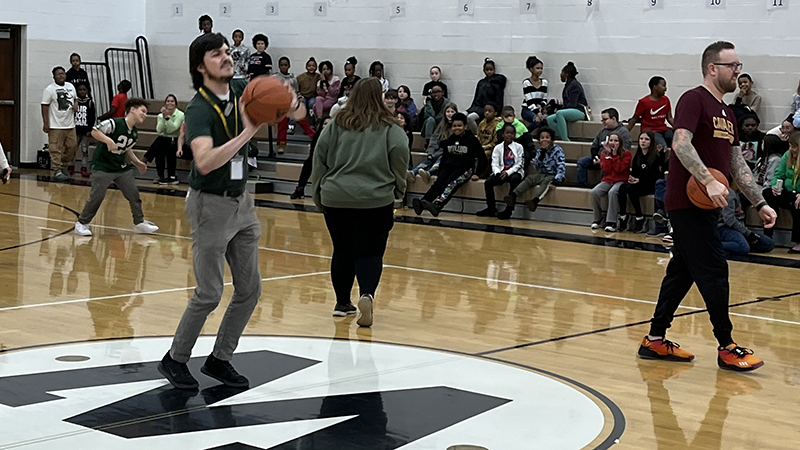 Mr. Fitch attempts a half court shot.