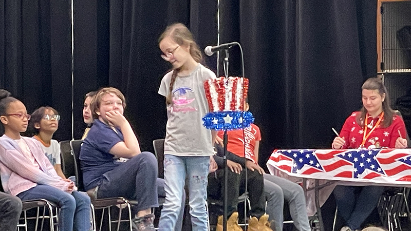 A student smiles after she gets a question correct.