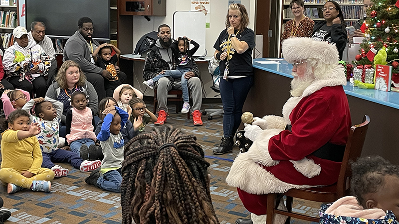 Students listen as Santa talks to them.
