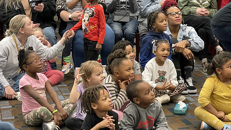 Students smile as they watch the show.