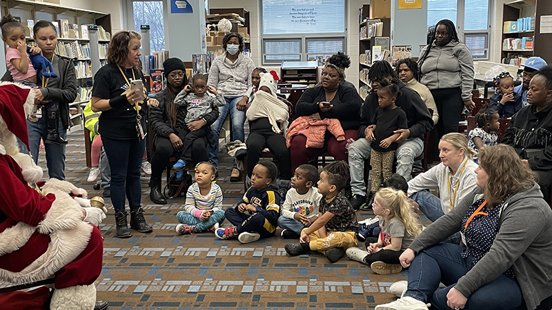 Students listen to directions about visiting with Santa.