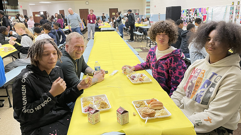 Mr. Cowell enjoys visiting with eighth grade students.