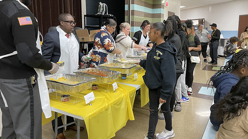 Middle school students receiving their meal.