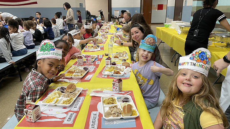 Miss Stacey enjoying lunch with a class.