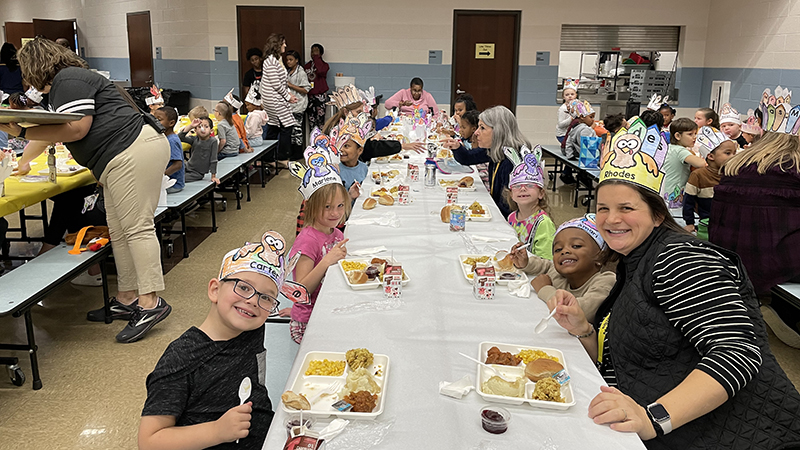 Mrs. Rhodes enjoys lunch with her students.