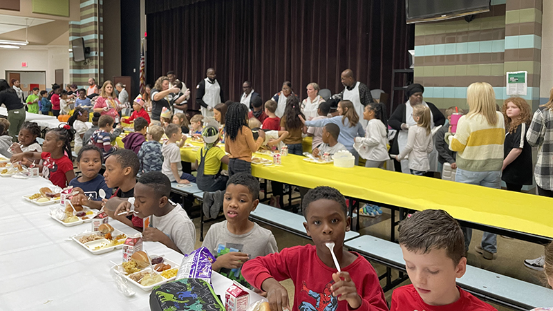 Volunteers help to dish out meals to staff and students.