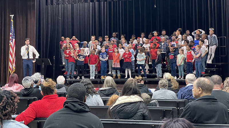 Second grade students perform a song.