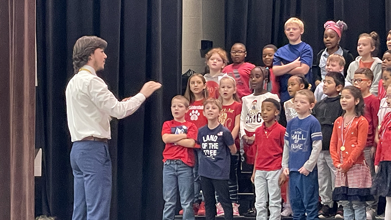 Mr. Fitch leads students during their performance.