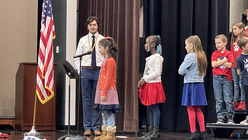 A student performs her poem for the program.