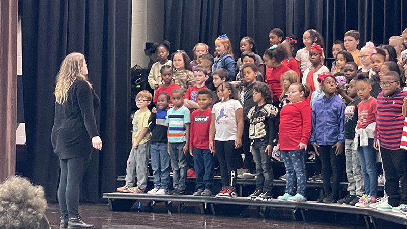 Second grade students begin their performance.