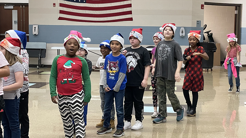 Second graders wait patiently for their gifts.