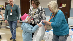 A student receives her bag of presents.