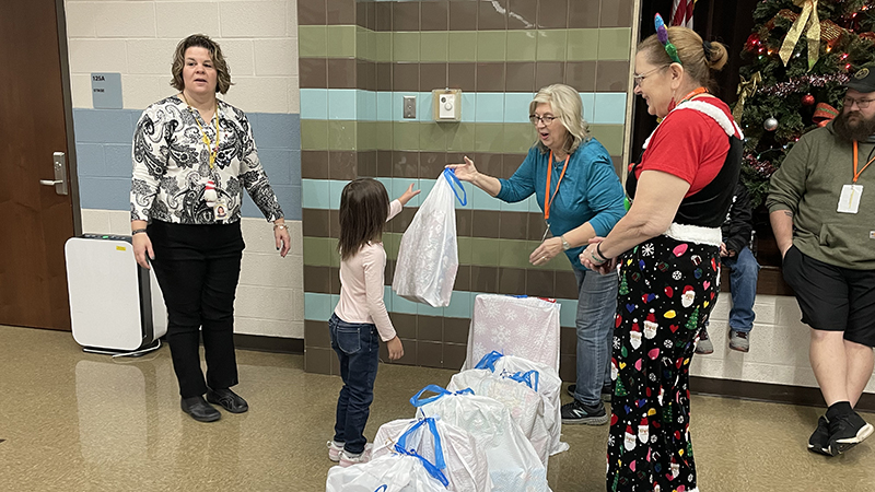 The first student receives her gifts.