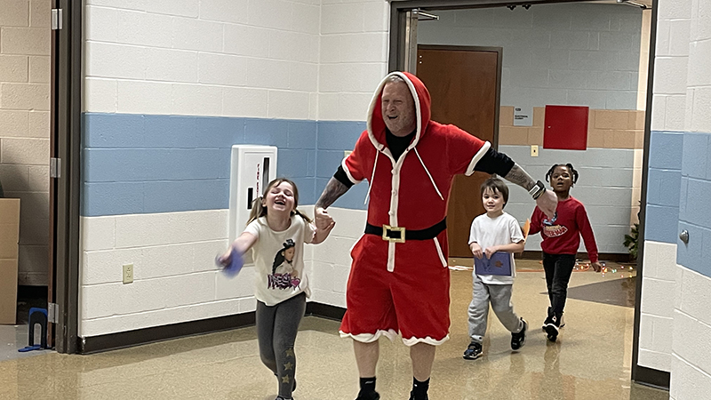 Mr. Cowell brings some excited students to get their gifts.