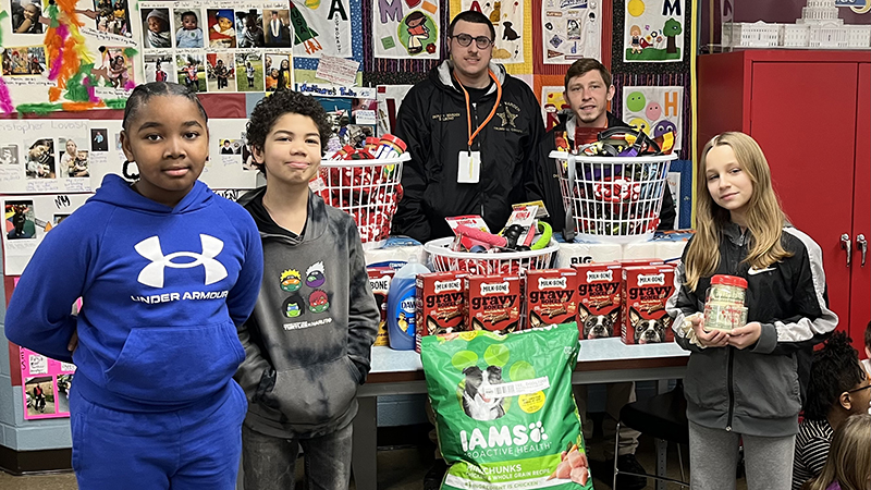 Students who led the service project stand with representatives from the Trumbull County Dog Pound.