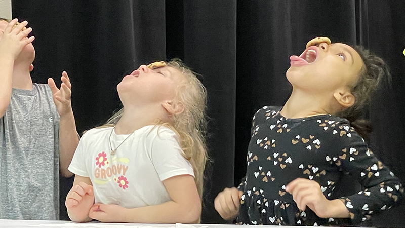 Students attempt the cookie face challenge.