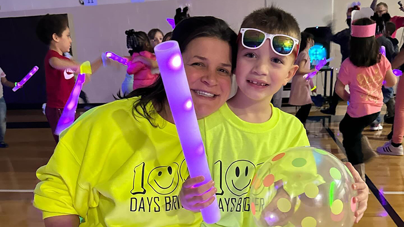 Mrs. Rhodes enjoys the glow party with a very special person.