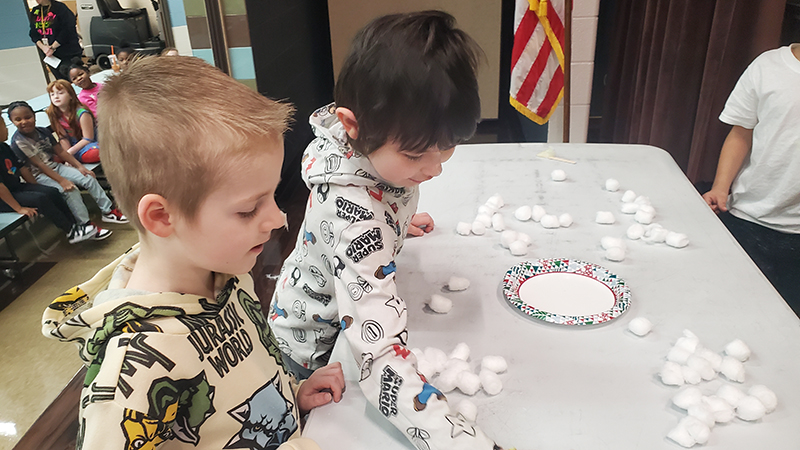 Students gather cotton balls for their challenge.