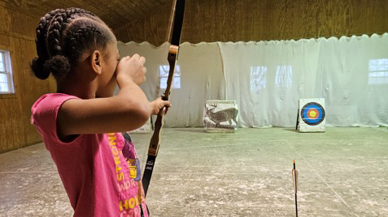 A student tries out archery.