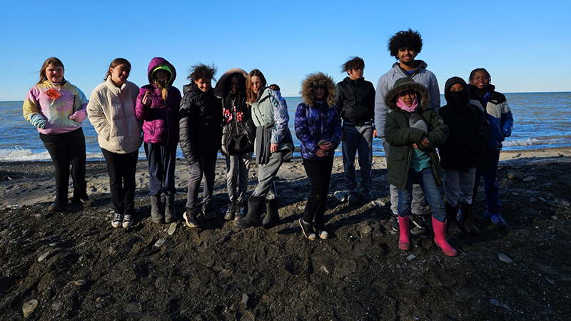 Students and their counselor enjoy time by the lake.