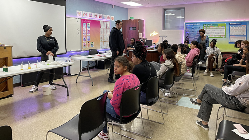 Students listen to TCTC students discuss a career in pharmaceuticals.