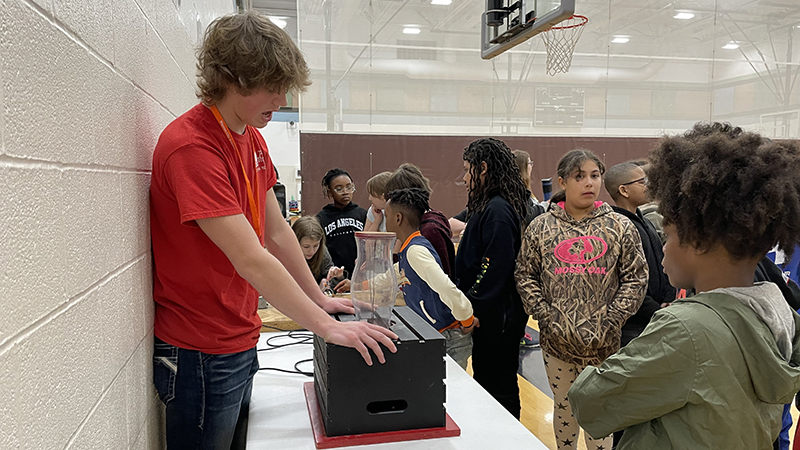 An electrical technician TCTC student explains the technology he is showing.