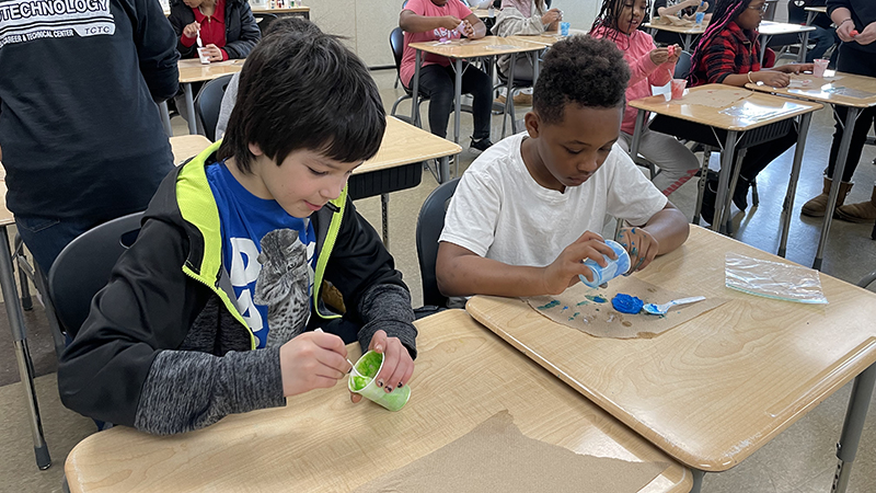 Students have fun mixing the chemicals for slime.