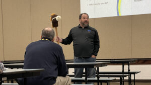 Coach Rudy speaks to staff in their morning meeting.