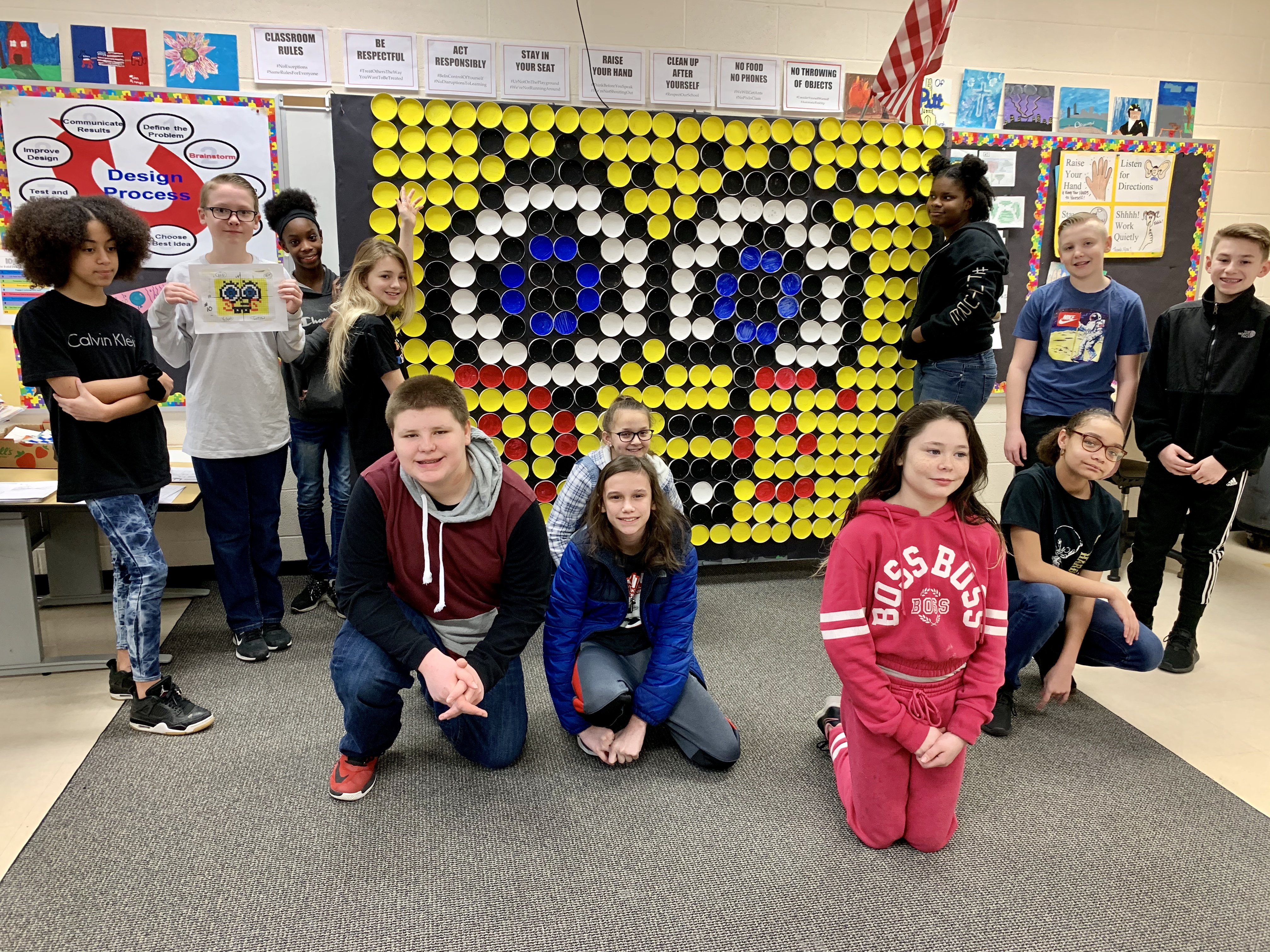 students in front of a sponge bob art picture