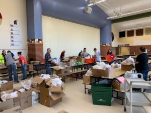 People packing up lunches for the students...boxes all around