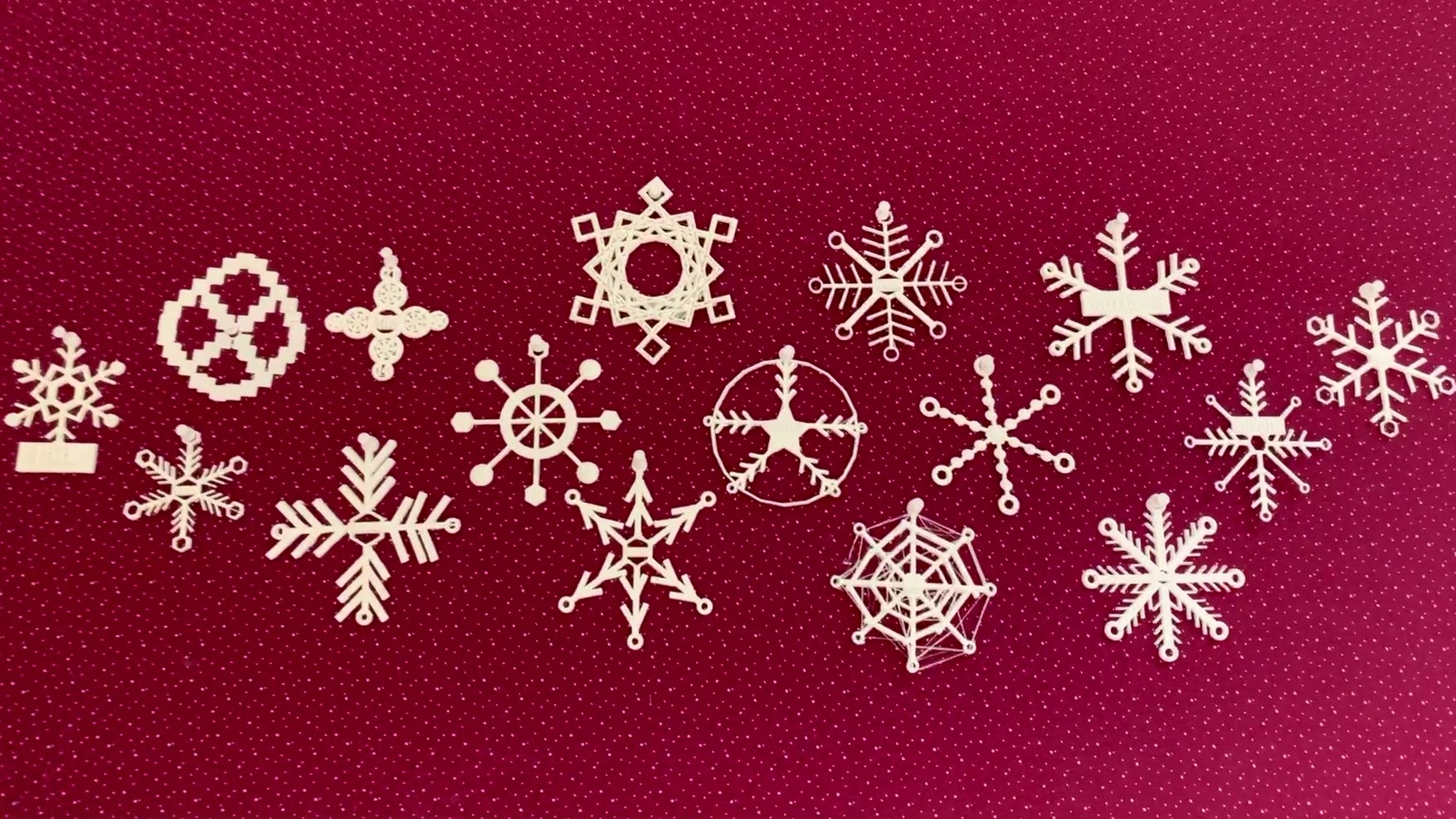 3D snowflakes on a red cloth display board