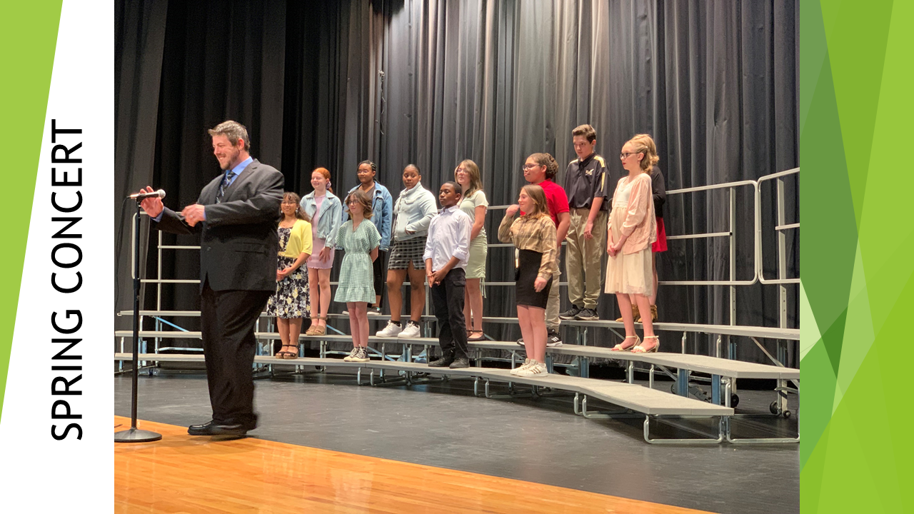 students standing on choir risers with director in front