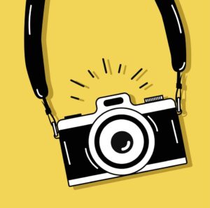 camera with neck strap and yellow background