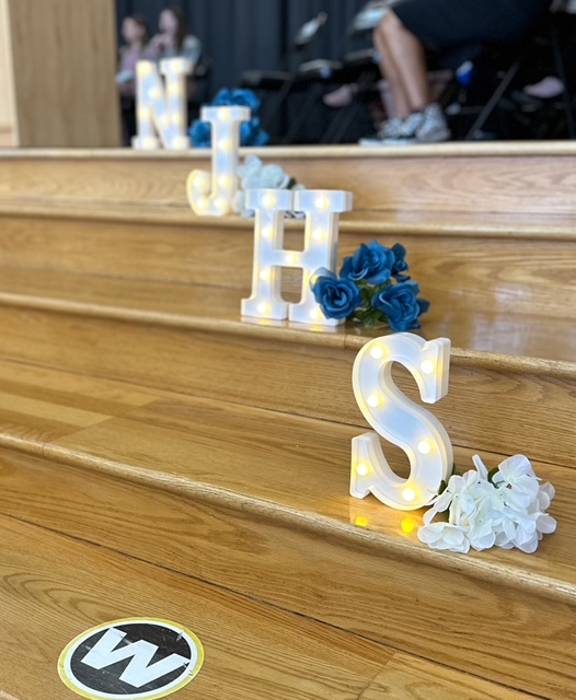 white and blue flowers next to letters