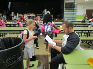 Mr. Baker reading a note of one of his students.
