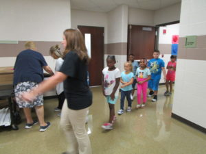 Mrs. Rolla taking her 1st grade class around the school.