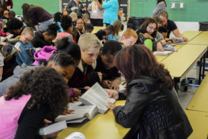 A Warren Rotary Club member reads portions of a dictionary with students