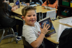 A Warren student shows off the dictionary he was given by the Warren Rotary Club