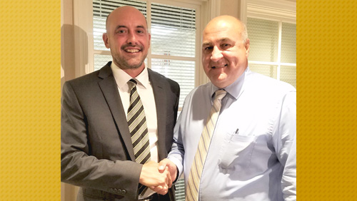 Gabe Bubon, new Boys Varsity Basketball Head Coach, left, and William Nicholson, Warren City Schools Athletic Director, right,