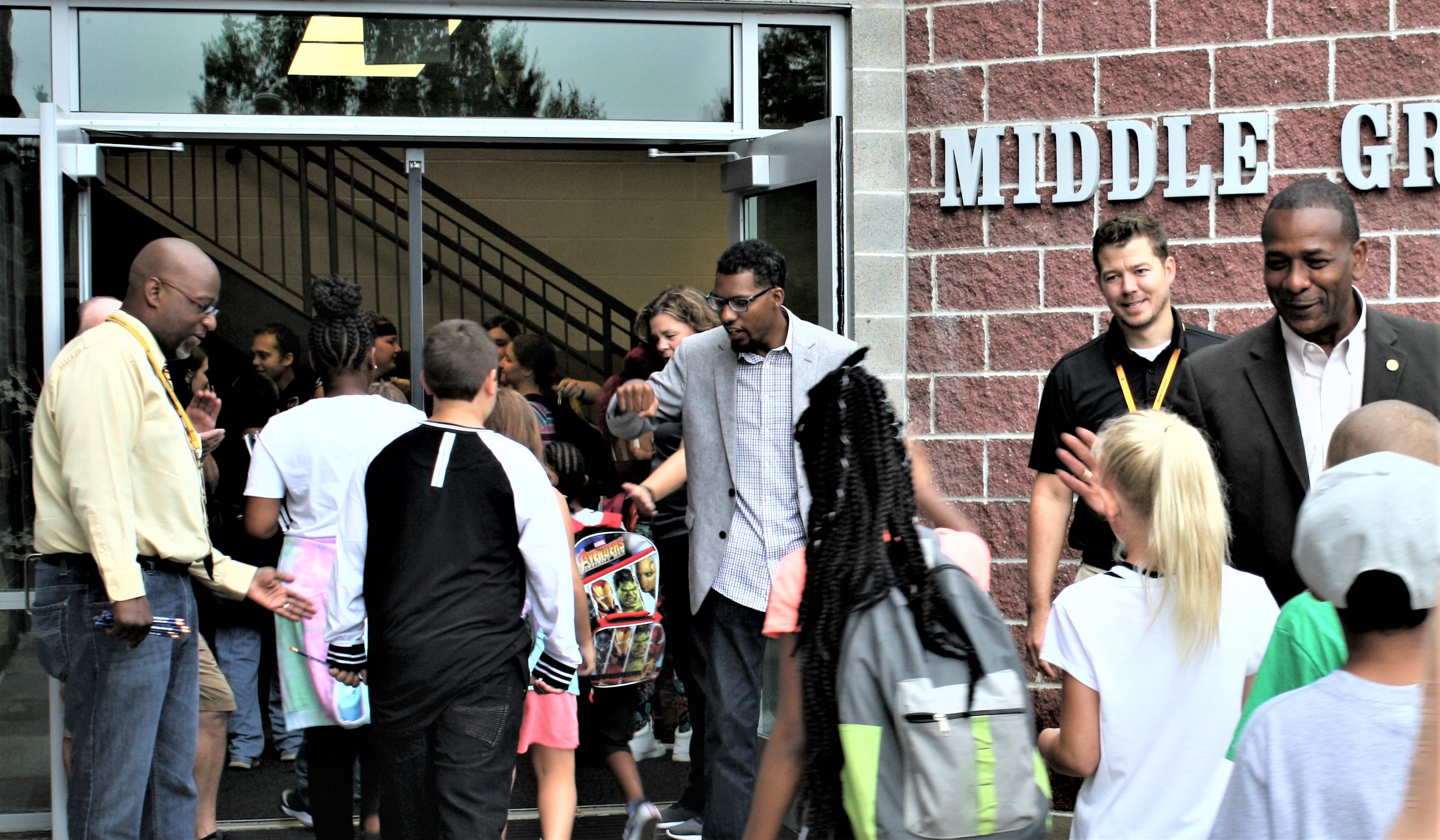 Volunteers greet students