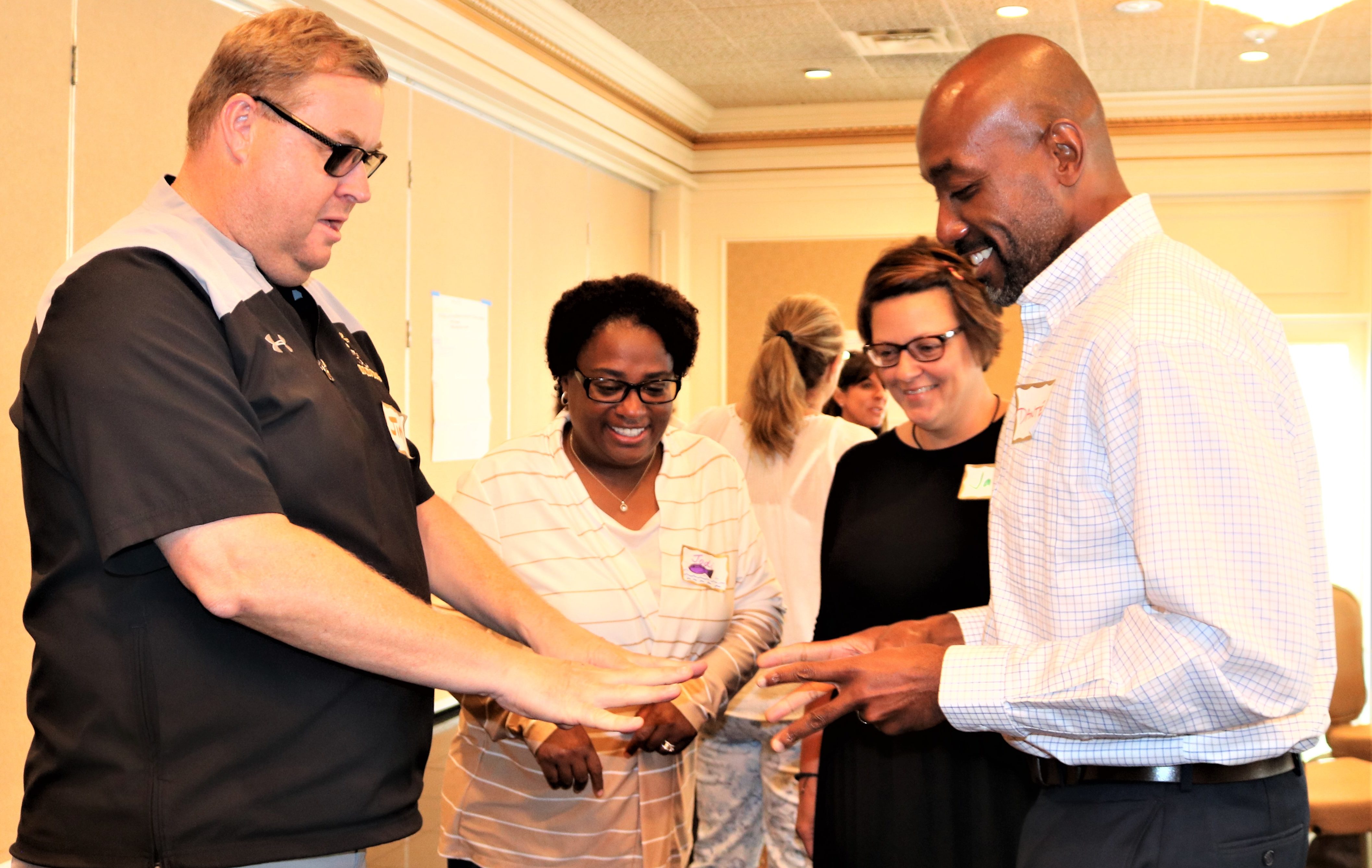 Warren City Schools' administrators compete in an elimination round of Finger Math Olympics.