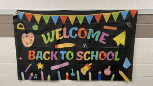 A banner in the hallway says "welcome back to school"
