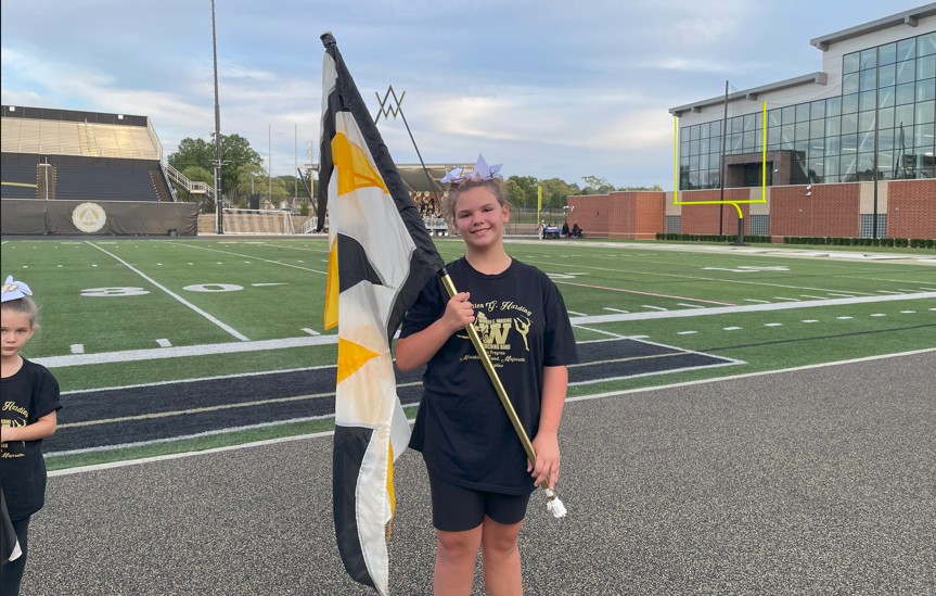 A Jefferson student performs with the flag line.